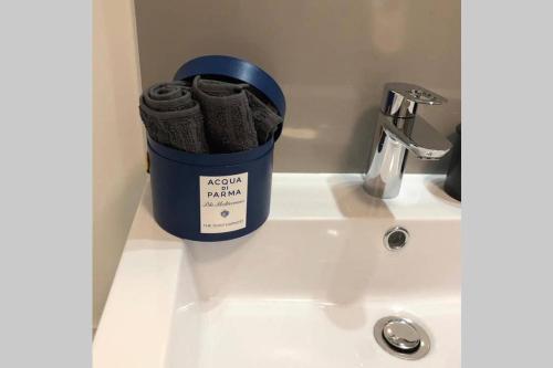 a mug sitting on a sink next to a faucet at CA DEI FIGLI, charmante maison de ville. in Bailly-Romainvilliers