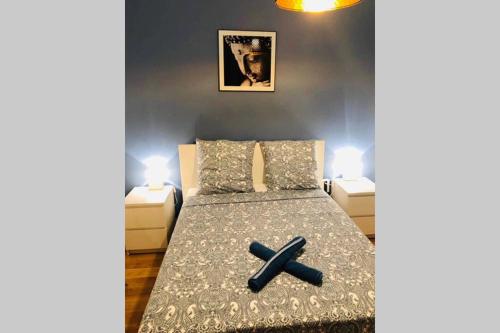 a bedroom with a bed with a cross on it at CA DEI FIGLI, charmante maison de ville. in Bailly-Romainvilliers