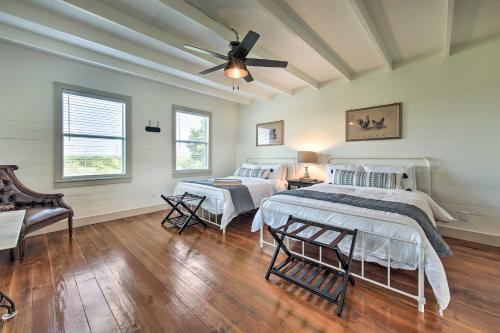 a bedroom with two beds and a ceiling fan at Chic Farmhouse - Wine Tasting and Church Tour! in Schulenburg