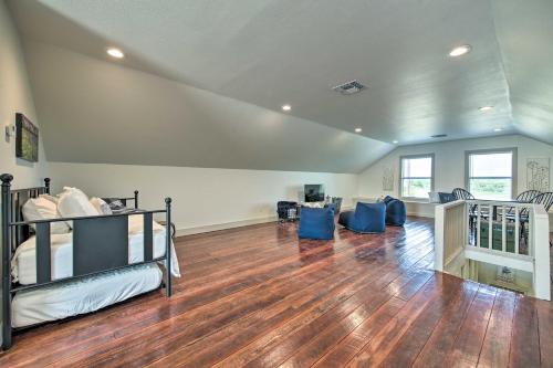 a room with two bunk beds and a hard wood floor at Peaceful Schulenburg Farmhouse with Fire Pit and Grill in Schulenburg