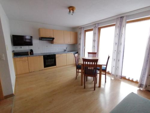 a kitchen and dining room with a table and chairs at Haus Viola in Samnaun