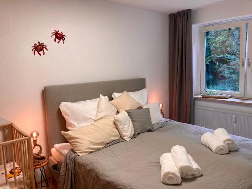 1 dormitorio con cama con almohadas y ventana en Pier39 Ferienwohnung Wassersleben Flensburg, en Harrislee