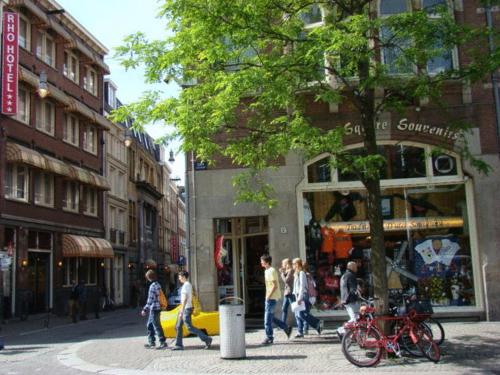 a street scene with people walking down the street at Rho Hotel in Amsterdam