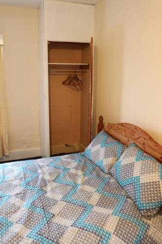 a bedroom with a bed and a closet at Lennard House in Folkestone