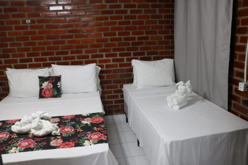 En eller flere senge i et værelse på Pousada Málaga