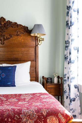 a bedroom with a bed and a lamp on a table at Garden Street Inn Downtown San Luis Obispo, A Kirkwood Collection Hotel in San Luis Obispo