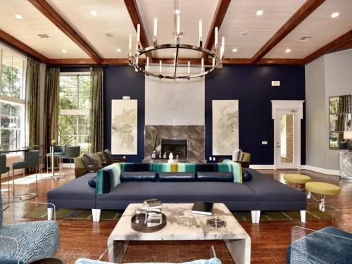 a living room with a blue couch and a fireplace at Lavish Apartment near Houston Medical Centre in Houston