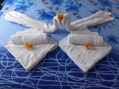 a group of towels sitting on top of a bed at Apartmani Slađo in Trebinje