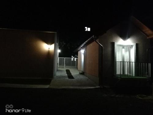 a dark alley with a building at night at Apartman TAJNA Vrdnik in Vrdnik