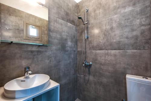 a bathroom with a sink and a shower at royal nest in Matala