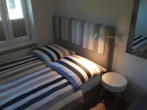 two beds in a small room with a window at Ferienwohnung 4 Familie Ramm in Eutin