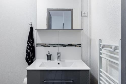 uma casa de banho com um lavatório e um espelho em Comfort Stay Basel Airport 2A46 em Saint-Louis