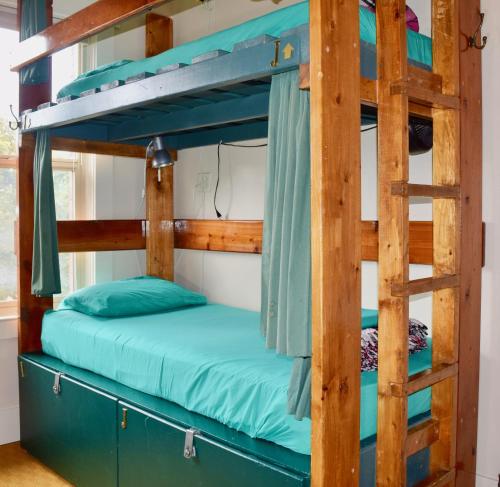 a bunk bed in a cabin with a ladder at Green Tortoise Hostel Seattle in Seattle
