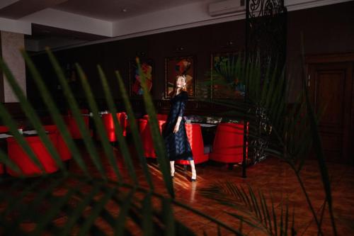 a woman is standing in a living room at Medeu in Kostanay