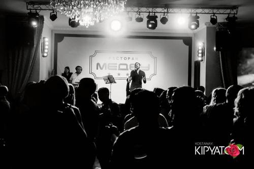 a man standing on a stage in front of a crowd at Medeu in Kostanay