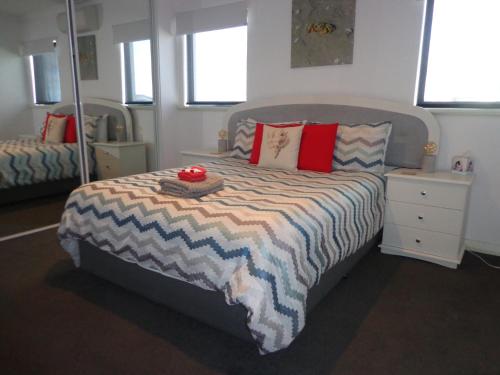 a bedroom with a bed with a hat on it at The Beach Villa Bunbury in Bunbury