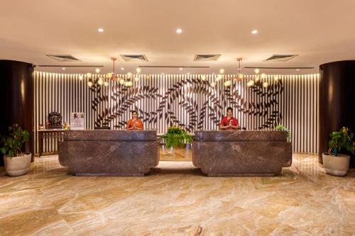 a lobby with a zebra patterned wall with two people in front at The Pride Hotel, Nagpur in Nagpur