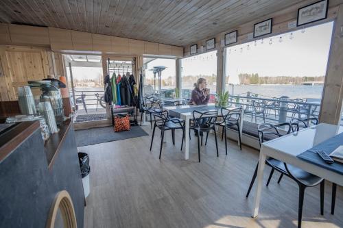 a woman sitting at a table on a boat at Koivuranta Igloos in Oulu