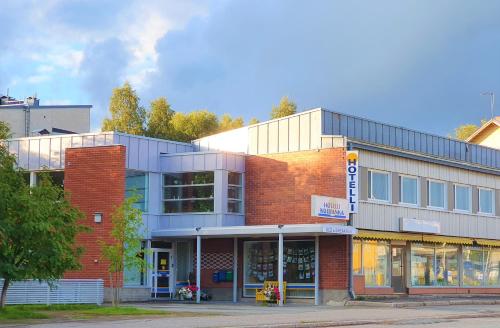 a store front of a brick building on a street at Hotel Kuusanka in Kuusamo