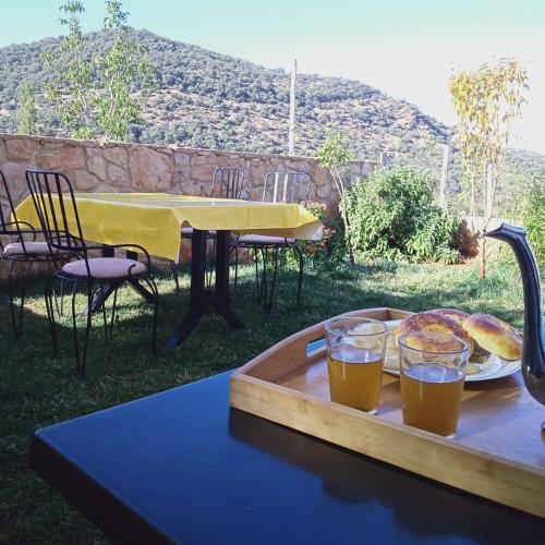 a table with a tray of food and drinks on it at Le Gite du Barrage in Zaouia Ben Smine