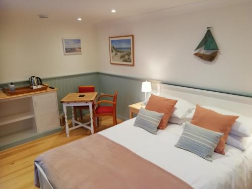a bedroom with a bed and a small table at Sea Breeze in Freshwater