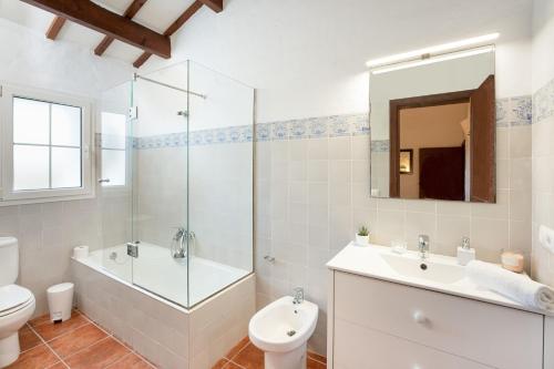 a bathroom with a toilet and a sink and a shower at Finca Estancia de Son Gras in Ferreries