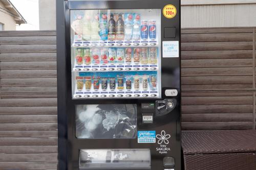 a soda vending machine with drinks in it at Stay SAKURA Kyoto TSUBAKI in Kyoto