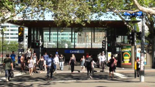 a group of people walking on a city street at Central Private Hotel in Sydney