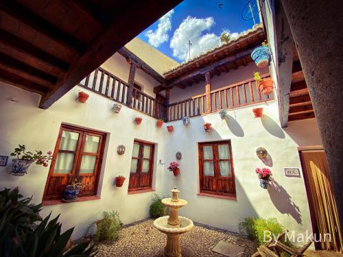 a white building with windows and a balcony at Cuevas Pedro Antonio de Alarcon in Guadix