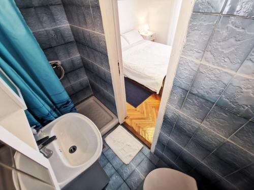 a small bathroom with a toilet and a sink at Studio Bobo in Rovinj