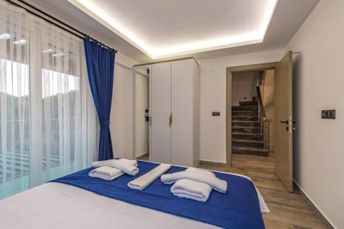 a bedroom with a bed with towels on it at Bella- 4 Bedroom Holiday Villa in Oludeniz in Fethiye