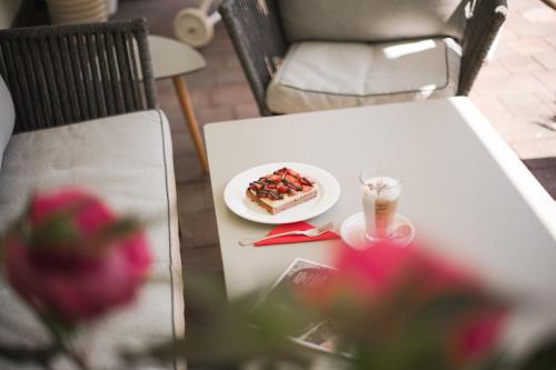 a plate of pizza on a table with a drink at Untermairhof B&B Christine in Lagundo