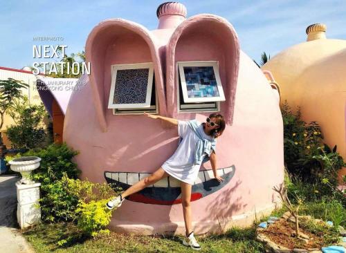 a young girl is standing in front of a house at Kenting Ha-Bi Star Fort in Hengchun