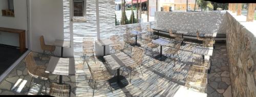 a group of chairs and tables on a balcony at AELLIA HOTEL & SUITES LEROS in Lakkíon