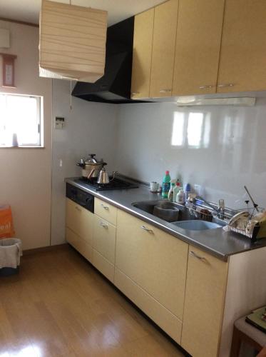 a kitchen with a sink and a counter top at 民泊Ｒｉｋａ in Tokai