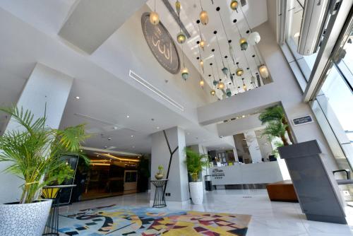 a lobby with potted plants in a building at Bram Hotel in Jeddah