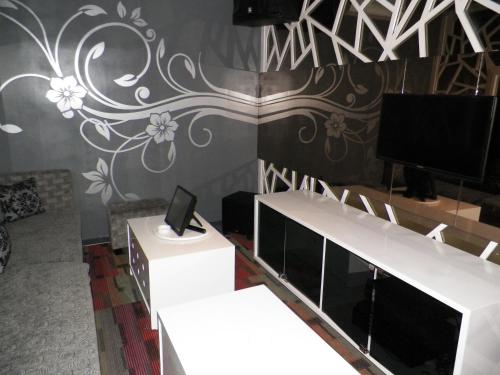 a living room with a tv on a wall at Sutanraja Hotel & Convention Centre in Soreang