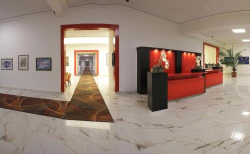 a lobby with marble floors and a corridor at Hotel PreMotel-Premium Motel am Park in Kassel