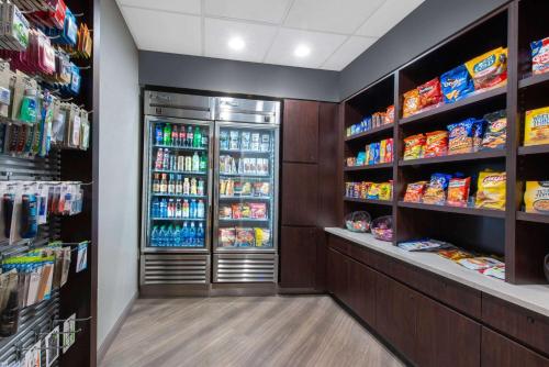 a grocery store aisle with a refrigerator and lots of food at La Quinta by Wyndham Tampa Brandon Regency Park in Brandon