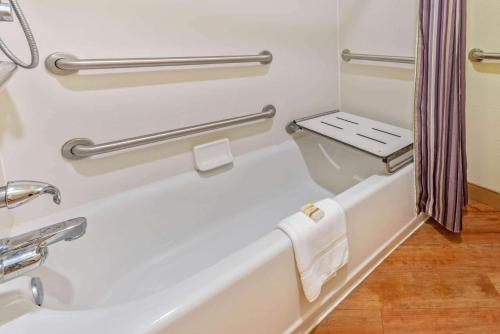 a bathroom with a bath tub and towel racks at La Quinta by Wyndham Tampa Brandon West in Tampa