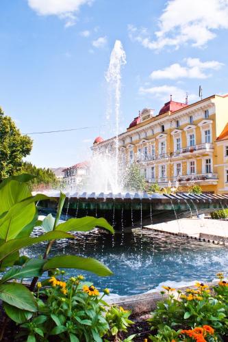 a water fountain in front of a building at Spa Hotel Diana in Františkovy Lázně