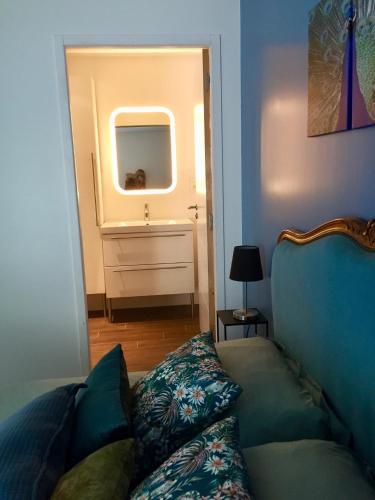 a living room with a couch and a mirror at La Longère du Salou in Landrévarzec