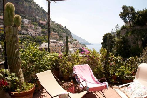 two chairs and cacti on a patio overlooking a city at Casa Celidea in Positano