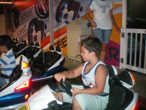 two young boys riding on a toy car at 103 ELEGANT 2 bed apartment with free Wifi, AC, pool & gym! in Larnaka
