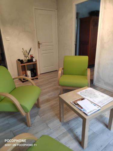 uma sala de estar com duas cadeiras e uma mesa de centro em Les ID de Saint Emilion em Saint-Émilion