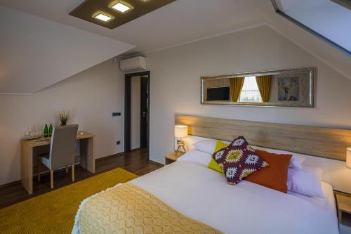 a bedroom with a bed and a desk at Vitis Kúria 7171 Balatonrendes in Balatonrendes