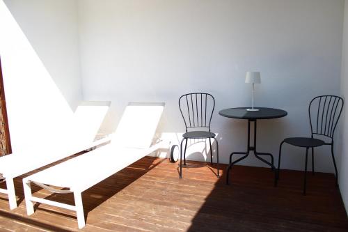 a wooden table and chairs in a room at Horta d'en Rahola - Adults Only in Cadaqués