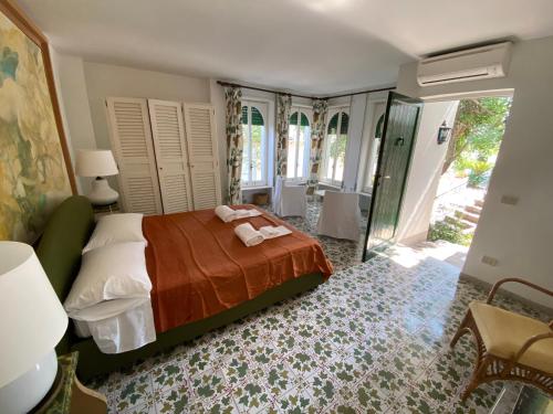 a bedroom with a bed with towels on it at Charming Villa in Capri