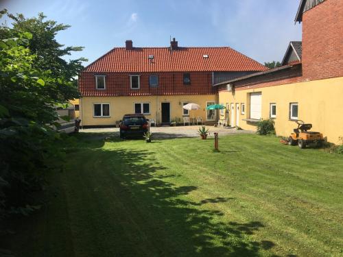 a car parked in a yard next to a house at Understedvej 103 in Sæby