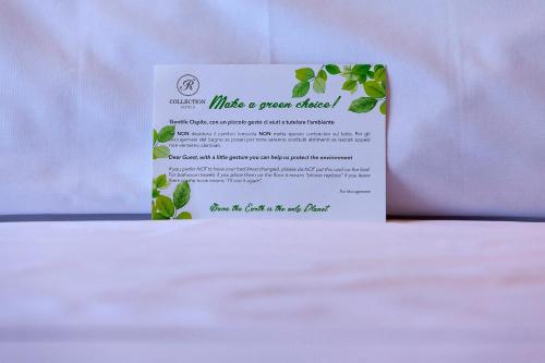 a white card with green leaves on a table at Hotel Royal Victoria, by R Collection Hotels in Varenna